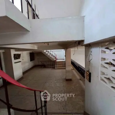 Spacious multi-level interior with open staircase and modern design elements.