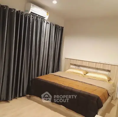 Cozy bedroom with modern decor and air conditioning, featuring elegant curtains and a comfortable bed.