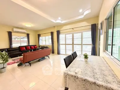 Spacious living room with modern furniture and large windows for natural light