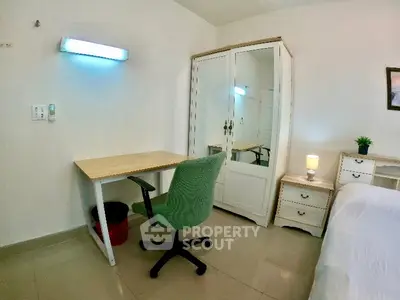 Cozy bedroom with study desk, chair, and wardrobe, perfect for a comfortable living space.