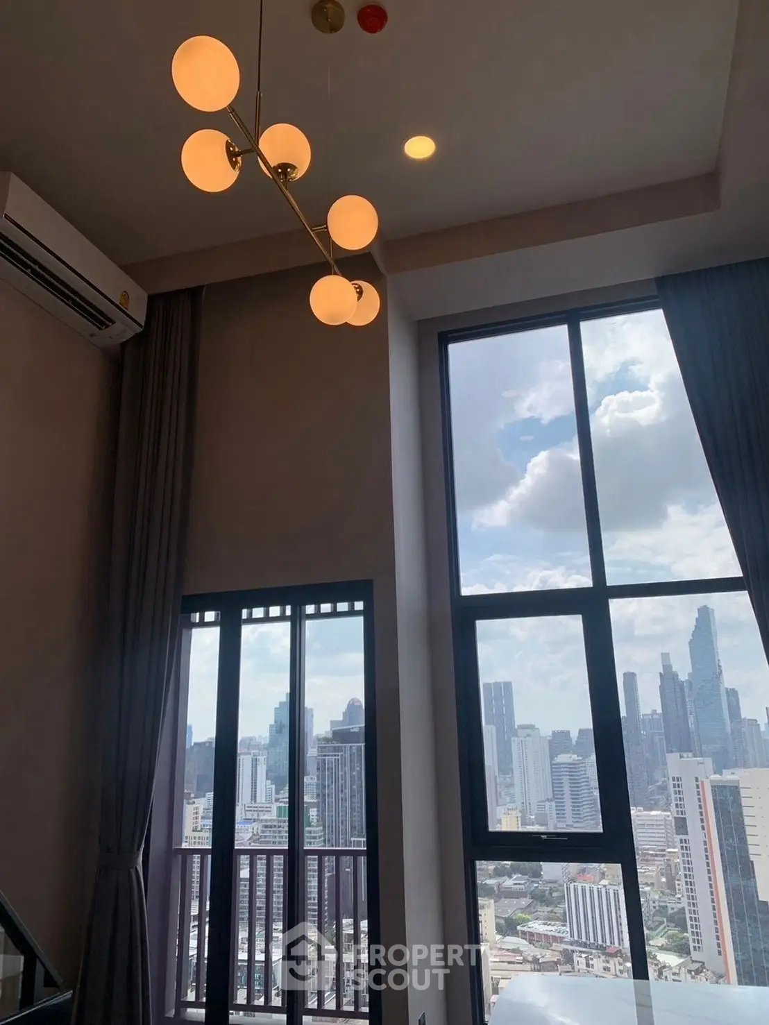 Stunning high-rise apartment with floor-to-ceiling windows and city skyline view.