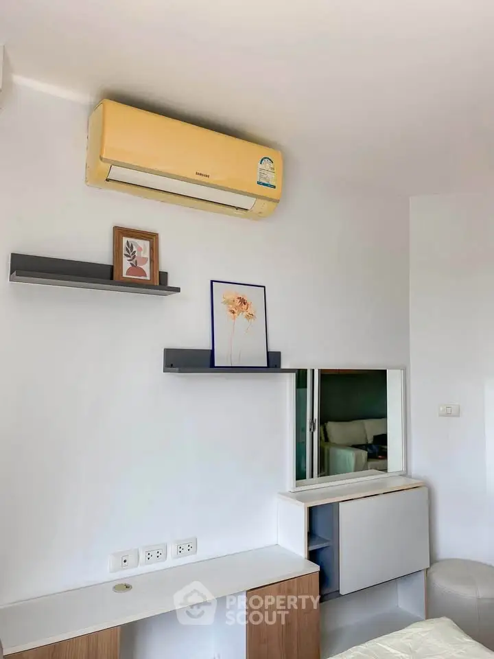 Modern interior with air conditioning and stylish shelving in a cozy living space.