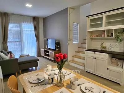 Charming living room with dining area, stylish decor, and cozy ambiance in modern home.