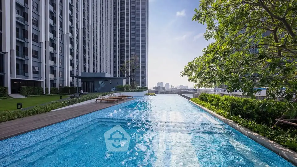 Luxurious high-rise apartment with stunning outdoor pool and lush greenery.
