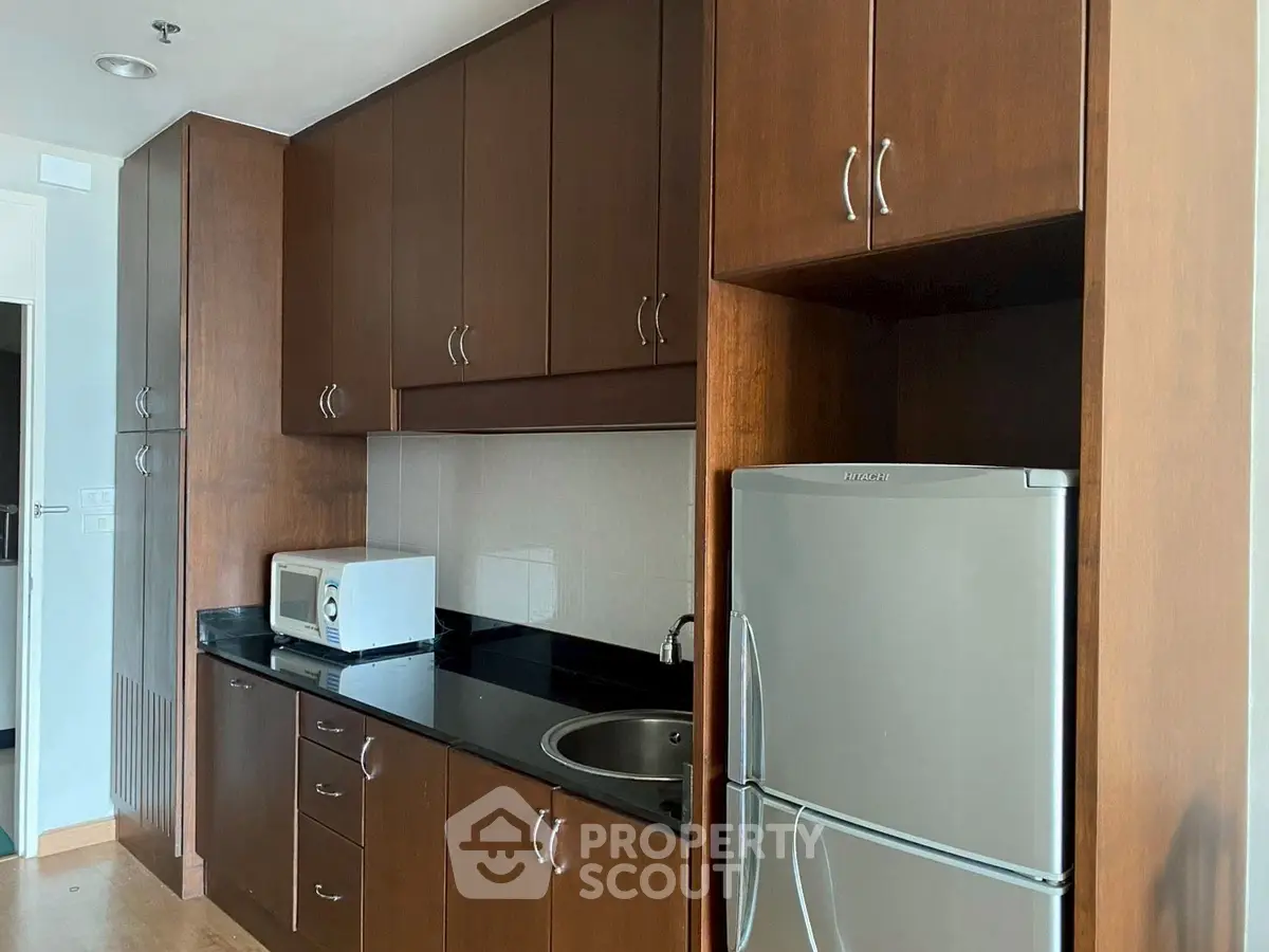Modern kitchen with wooden cabinets and stainless steel appliances