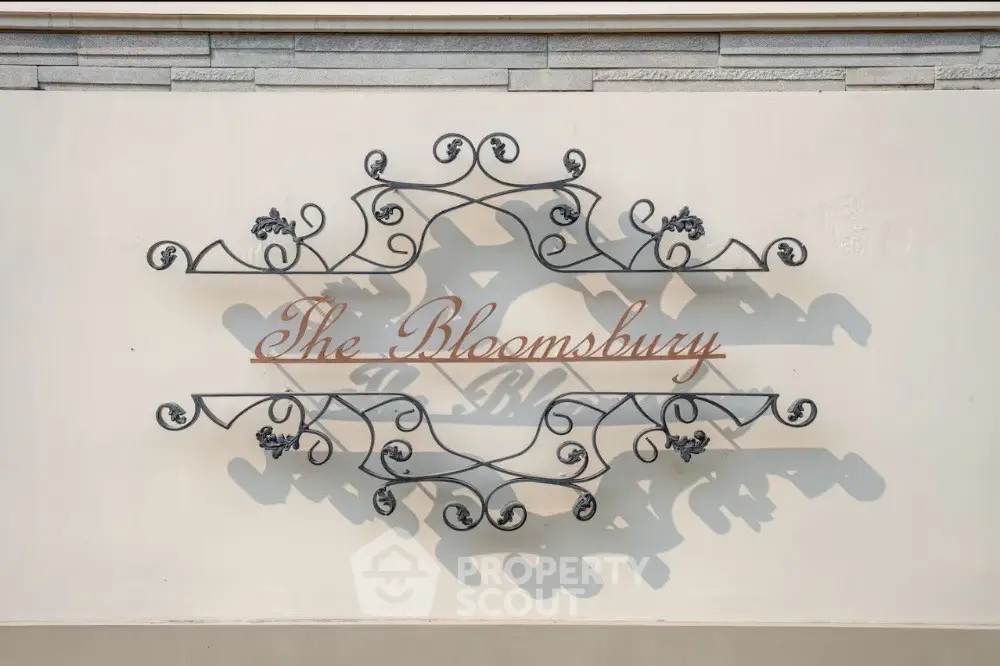 Elegant decorative sign with intricate metalwork at The Bloomsbury entrance.
