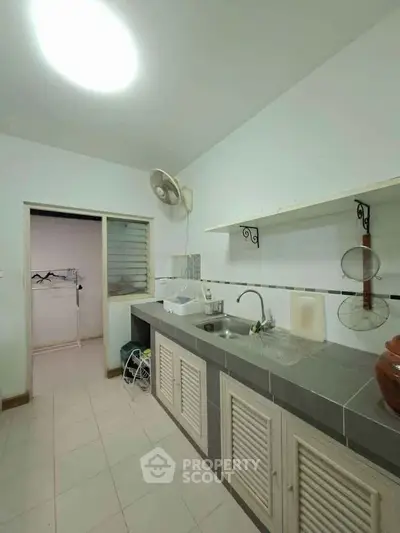 Spacious kitchen with modern sink and ample storage space