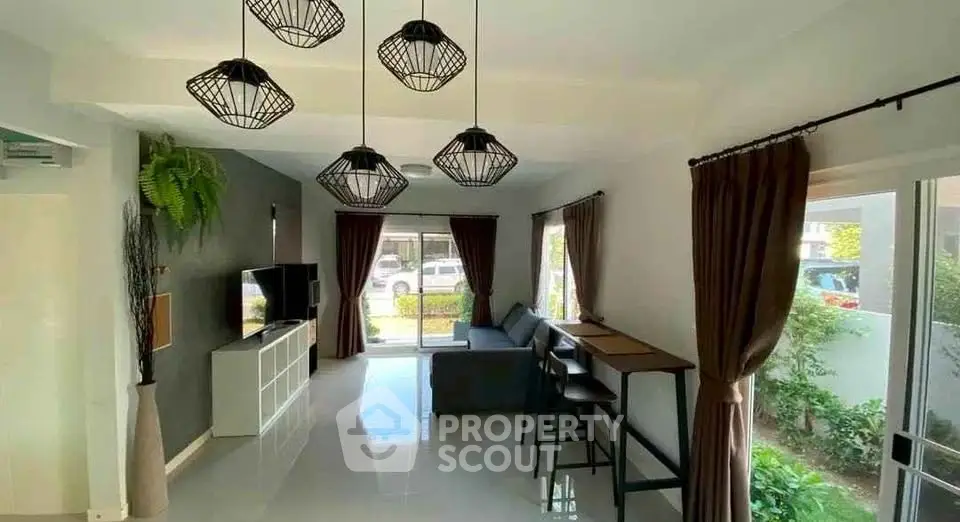 Spacious modern living room with stylish lighting and garden view