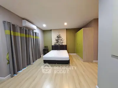 Spacious bedroom with modern decor and ample natural light, featuring a comfortable bed and stylish wardrobe.