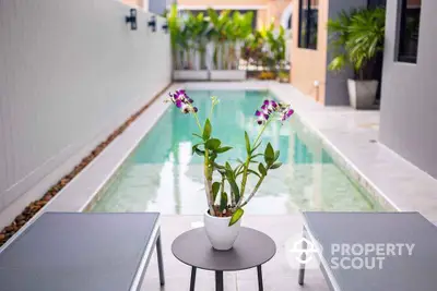 Luxurious private pool with modern outdoor seating and vibrant plants