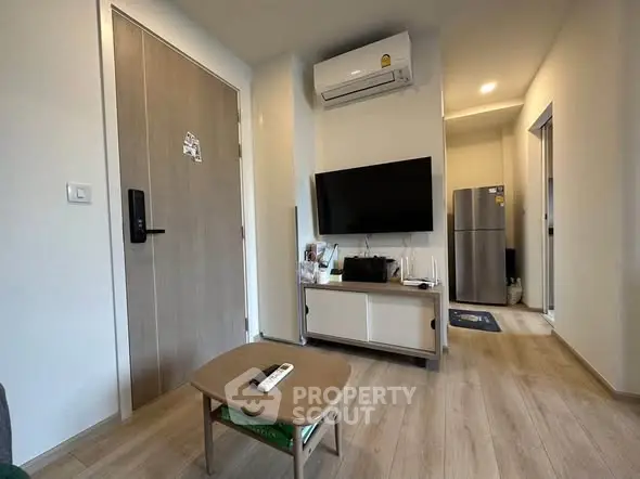Modern living room with air conditioning and sleek wooden flooring