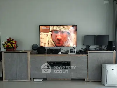 Modern living room with sleek entertainment center and dual monitors