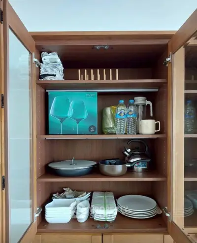 Spacious kitchen cabinet with organized shelves and modern kitchenware
