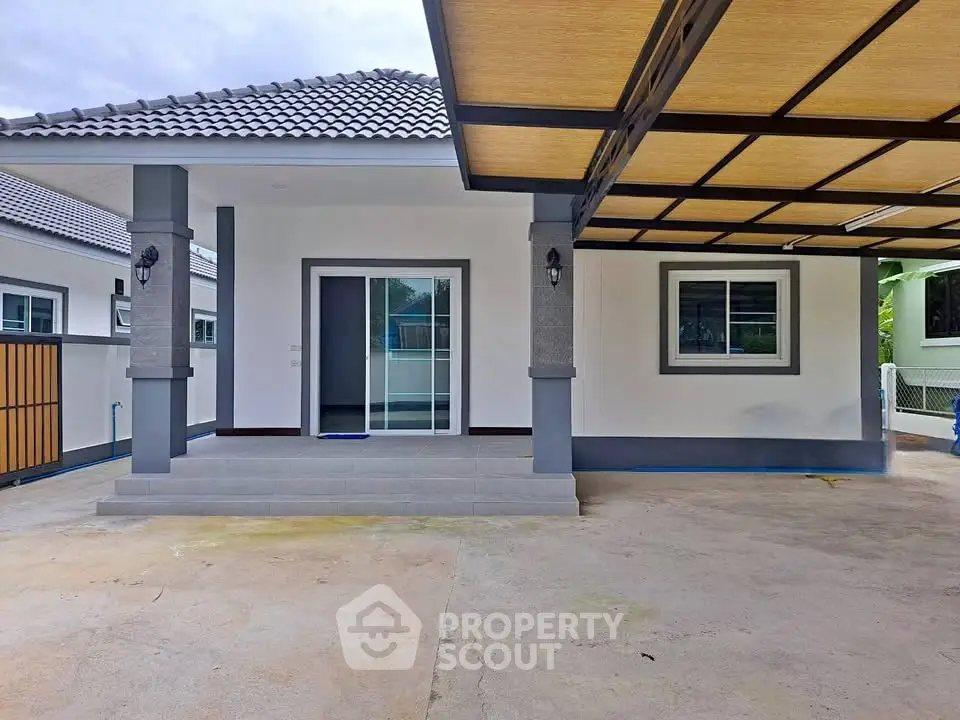 Charming single-story home with covered carport and modern entrance in a serene neighborhood.