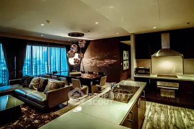 Luxurious open-plan living room and kitchen with modern decor and city view.