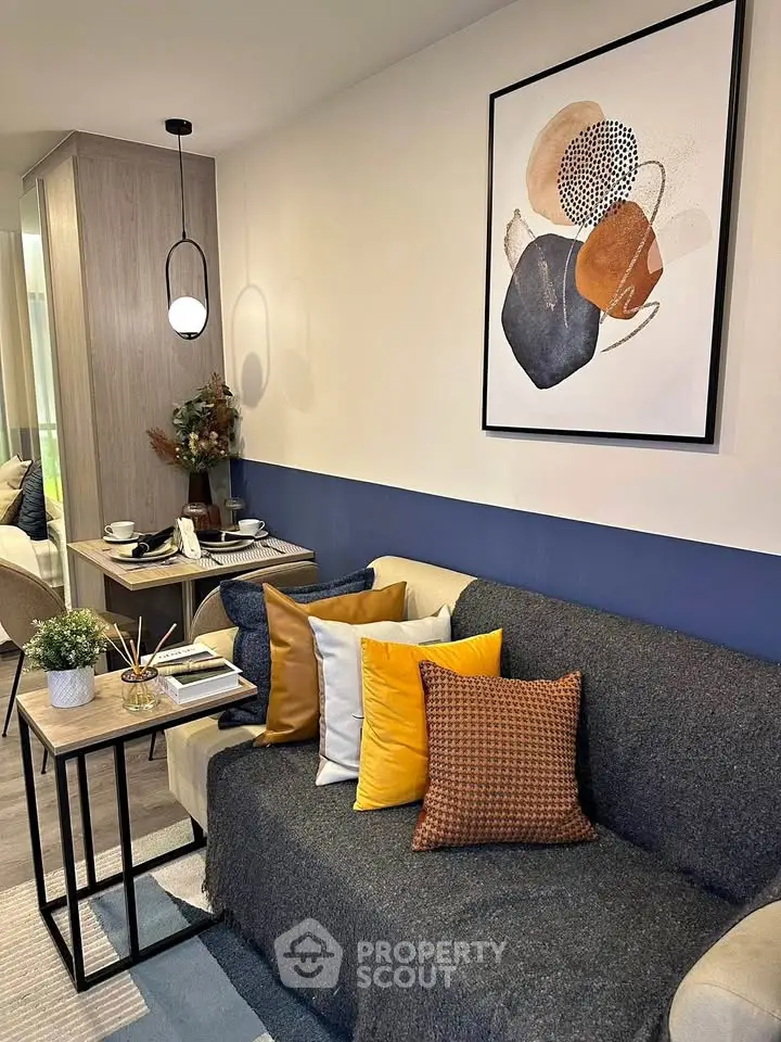 Stylish modern living room with cozy sofa and abstract art on wall