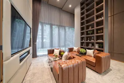 Luxurious living room with high ceilings, elegant decor, and large windows offering a serene garden view.