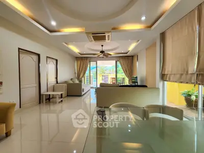Spacious modern living room with elegant decor and large windows offering natural light.