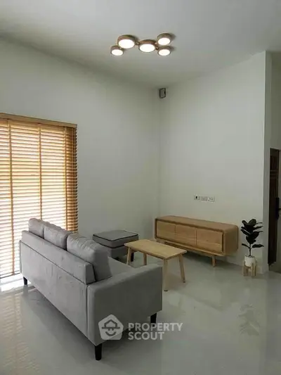 Modern minimalist living room with sleek furniture and natural light