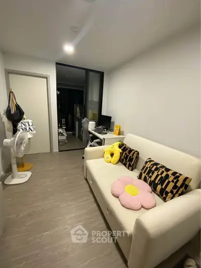 Cozy living room with modern decor and comfortable seating in a stylish apartment.
