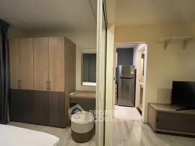 Modern bedroom with stylish furniture and sleek design, featuring a cozy bed and ample storage space.
