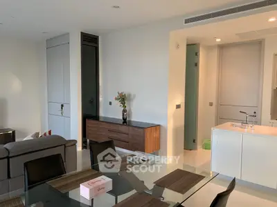 Modern open-plan living room with sleek furniture and dining area