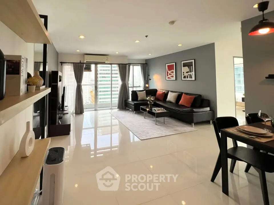 Spacious modern living room with sleek design and city view balcony.