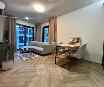 Modern living room with stylish furniture and large windows in a contemporary apartment.