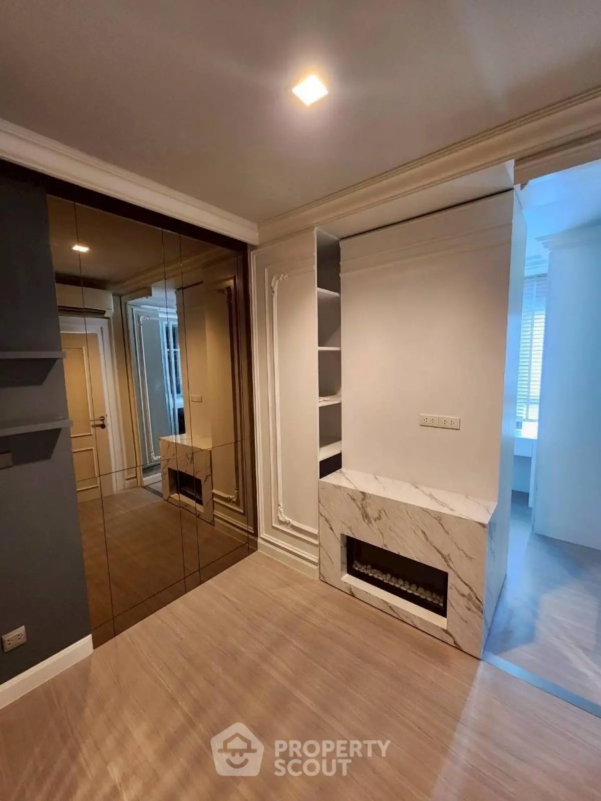 Elegant interior with marble fireplace and mirrored wall in modern living space