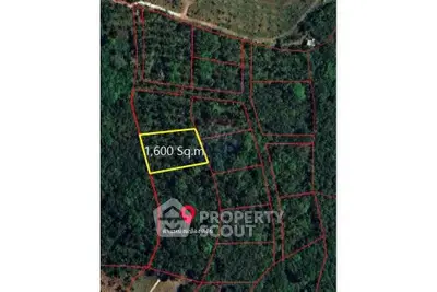 Aerial view of a 1600 sqm land plot in a lush green area, ideal for development.