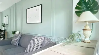 Chic living room with stylish decor and cozy gray sofa, perfect for modern living.