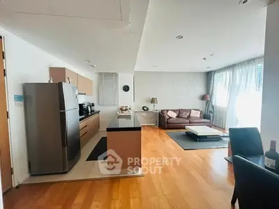 Spacious open-layout kitchen and living room with modern appliances and hardwood floors.