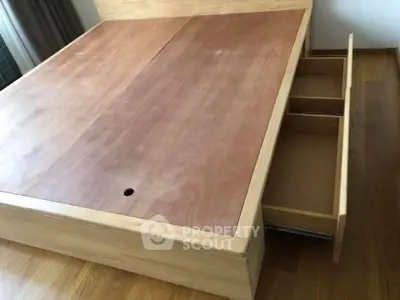 Spacious wooden bed frame with built-in storage drawers, perfect for modern bedroom organization.