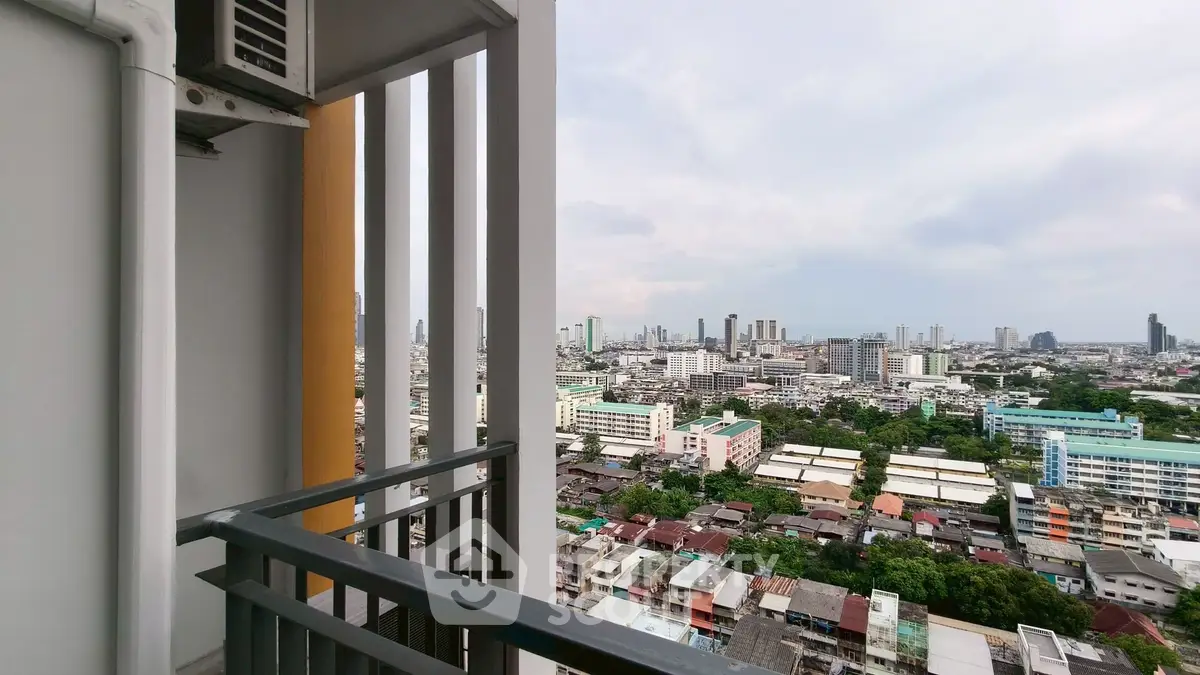 Stunning city view from high-rise balcony with modern railing design.