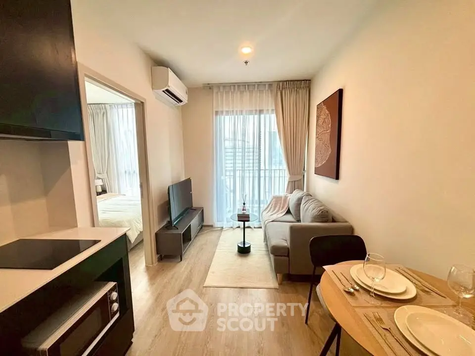 Modern open-plan living room with cozy sofa and dining area in stylish apartment.