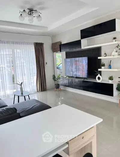 Modern living room with sleek entertainment center and large windows