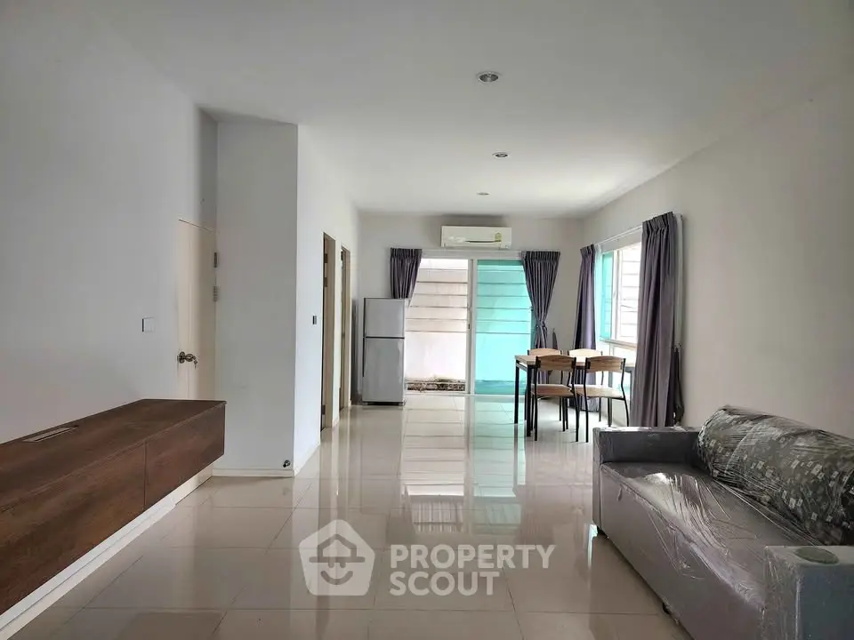 Spacious modern living room with sleek furniture and large windows for natural light.