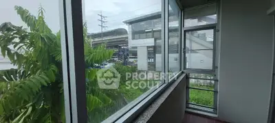 Spacious balcony with urban view near public transportation hub