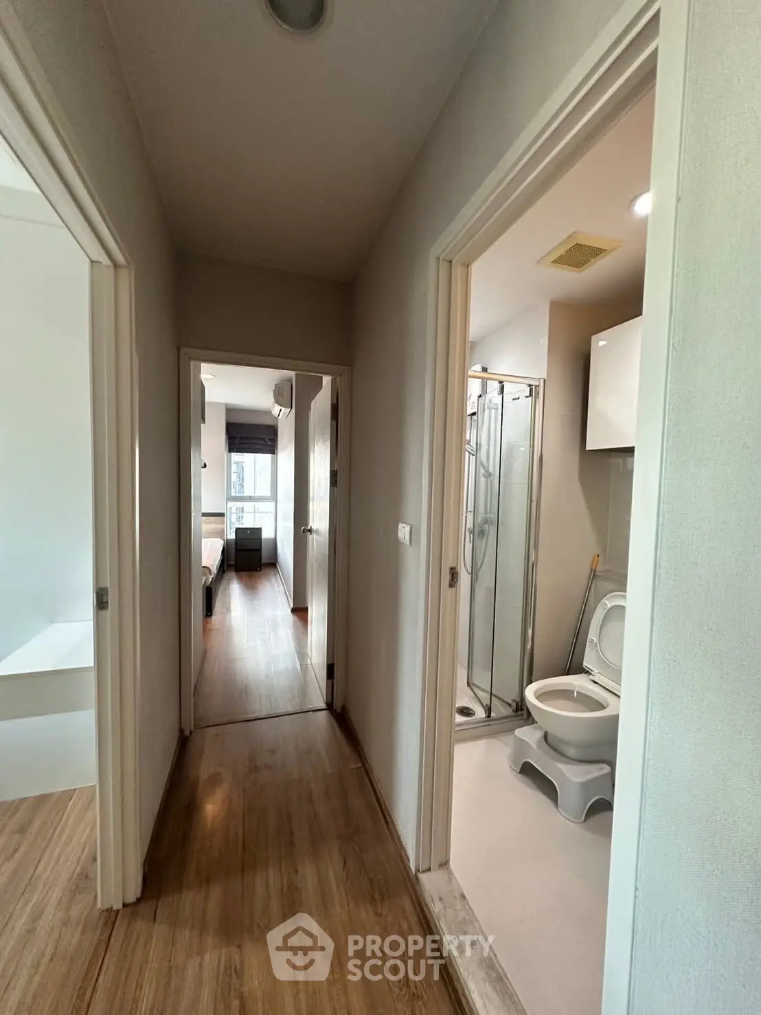 Modern apartment hallway with bathroom and bedroom view