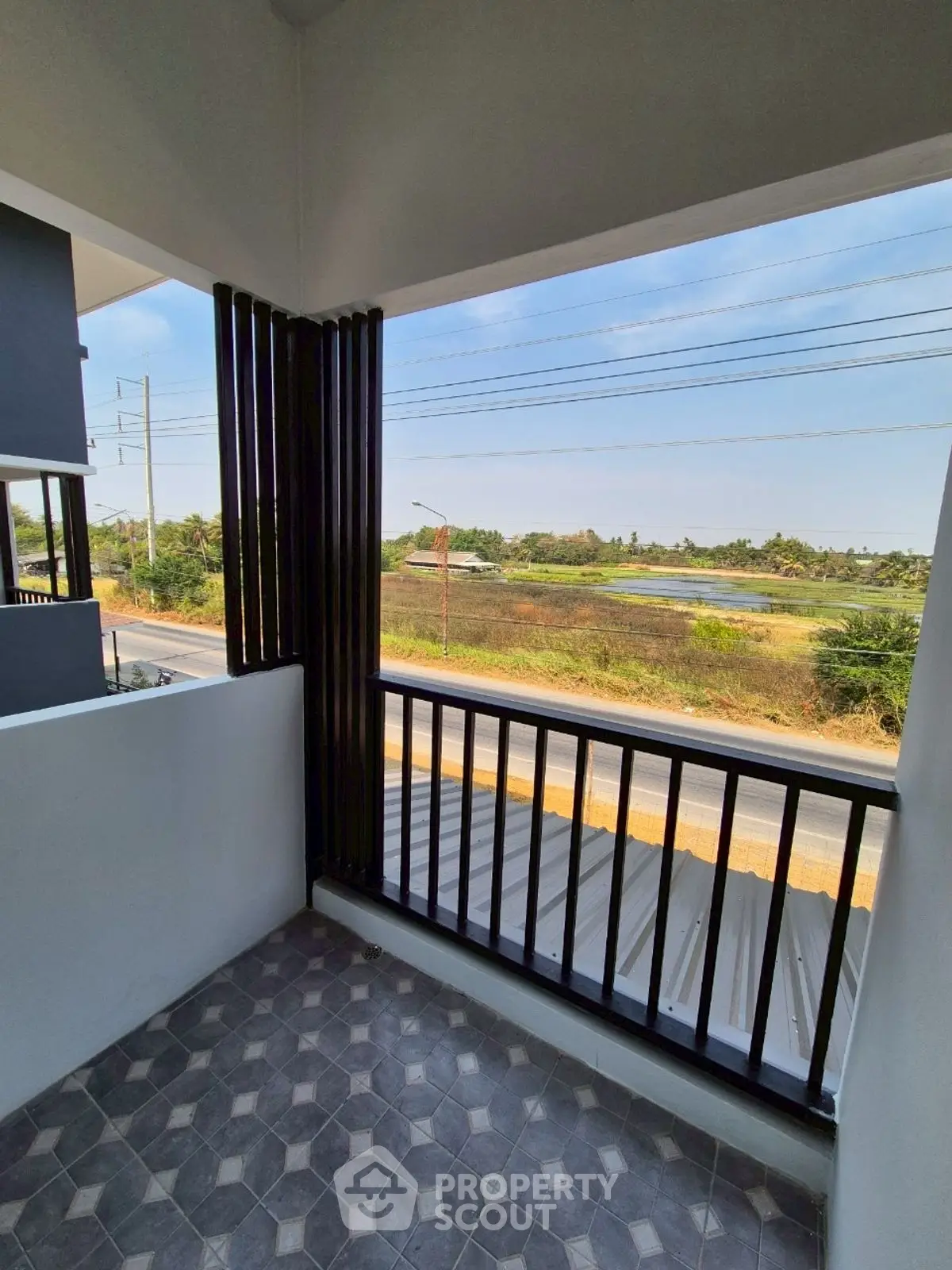 Charming balcony with serene countryside view, perfect for relaxation and enjoying nature.