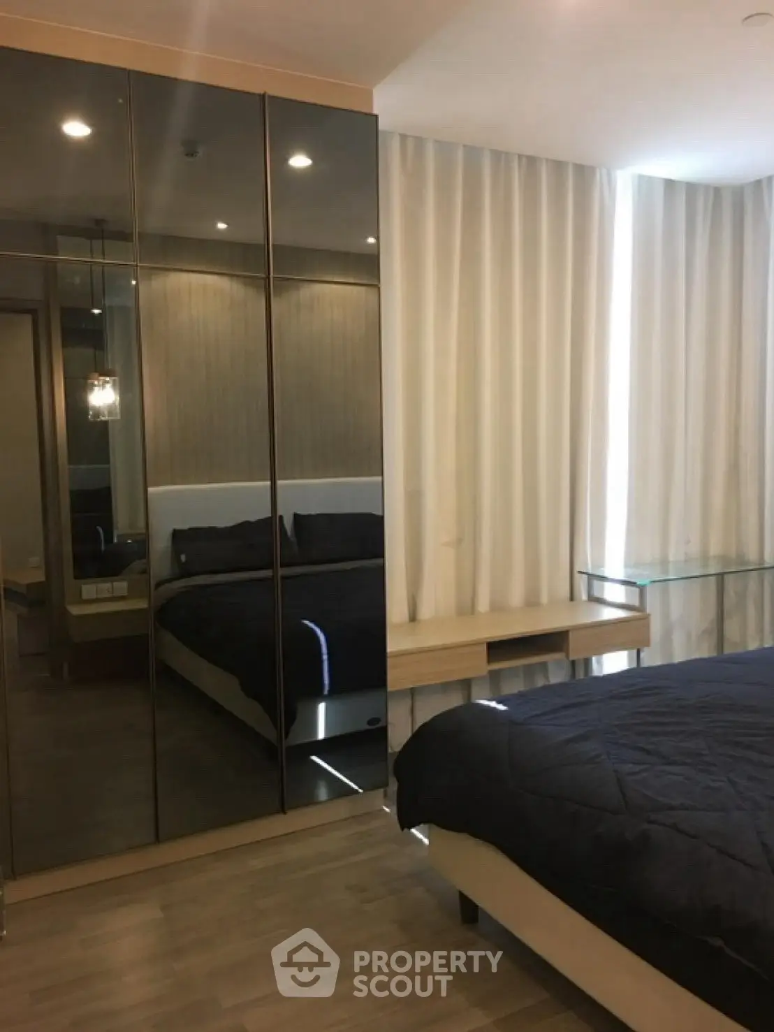 Modern bedroom with mirrored wardrobe and elegant decor