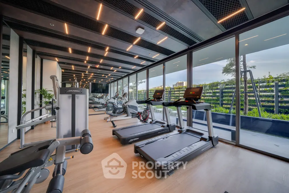 Modern gym with state-of-the-art equipment and scenic outdoor view