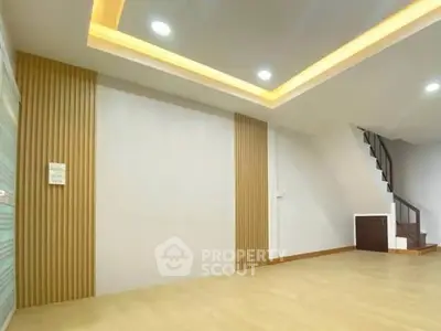 Spacious modern living room with stylish ceiling lights and wooden accents