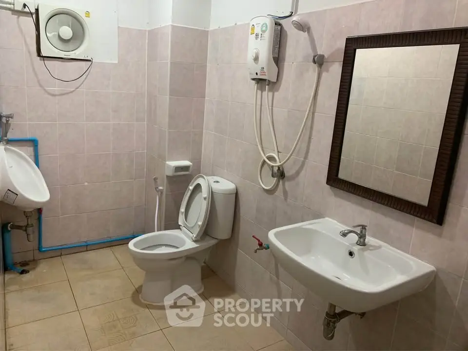 Modern bathroom with essential fixtures and water heater