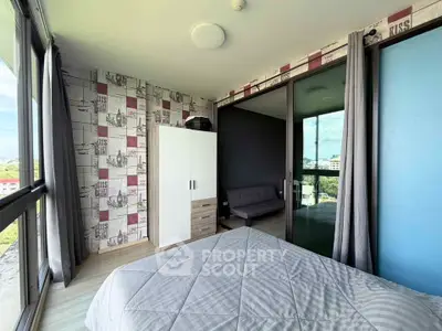 Modern bedroom with large windows and stylish decor in a high-rise apartment.