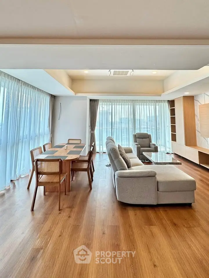 Spacious living room with modern furniture and large windows for natural light.