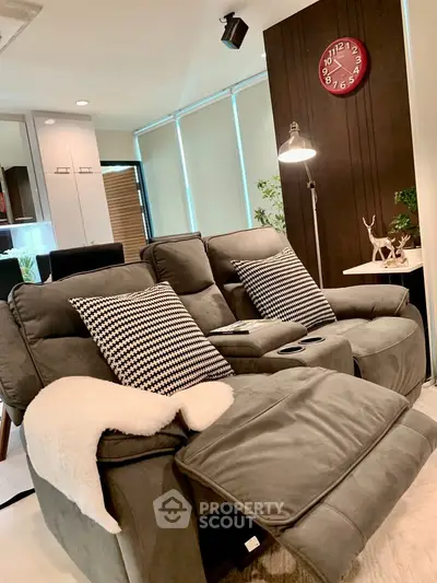 Cozy living room with plush recliners and modern decor, perfect for relaxation and entertainment.