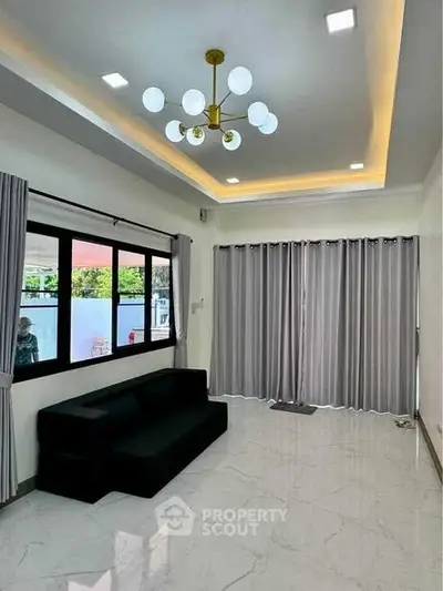 Spacious modern living room with elegant lighting and large windows