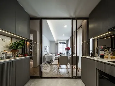 Modern open-layout kitchen leading to a stylish living room with elegant decor.