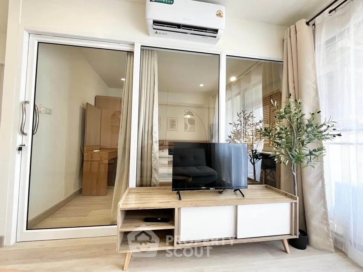 Modern living room with sleek TV stand and glass sliding doors